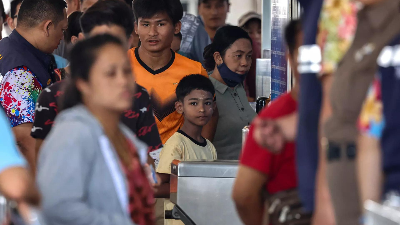People cross the Thailand-Myanmar Friendship Bridge as a stream of people queued at a border crossing to flee Myanmar early on Friday (Reuters photo)