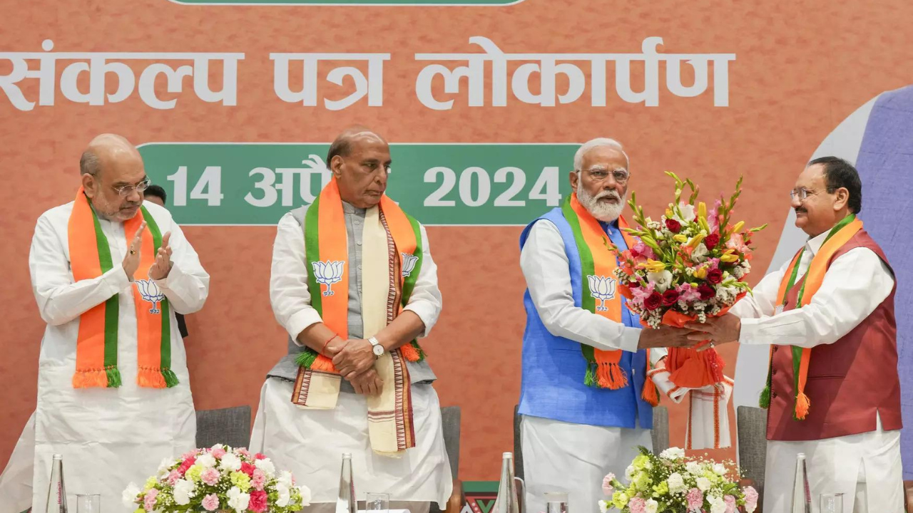 PM Narendra Modi being felicitated by BJP National President JP Nadda during the release of the party manifesto ‘Sankalp Patra’ at the party headquarters, in New Delhi. (PTI)