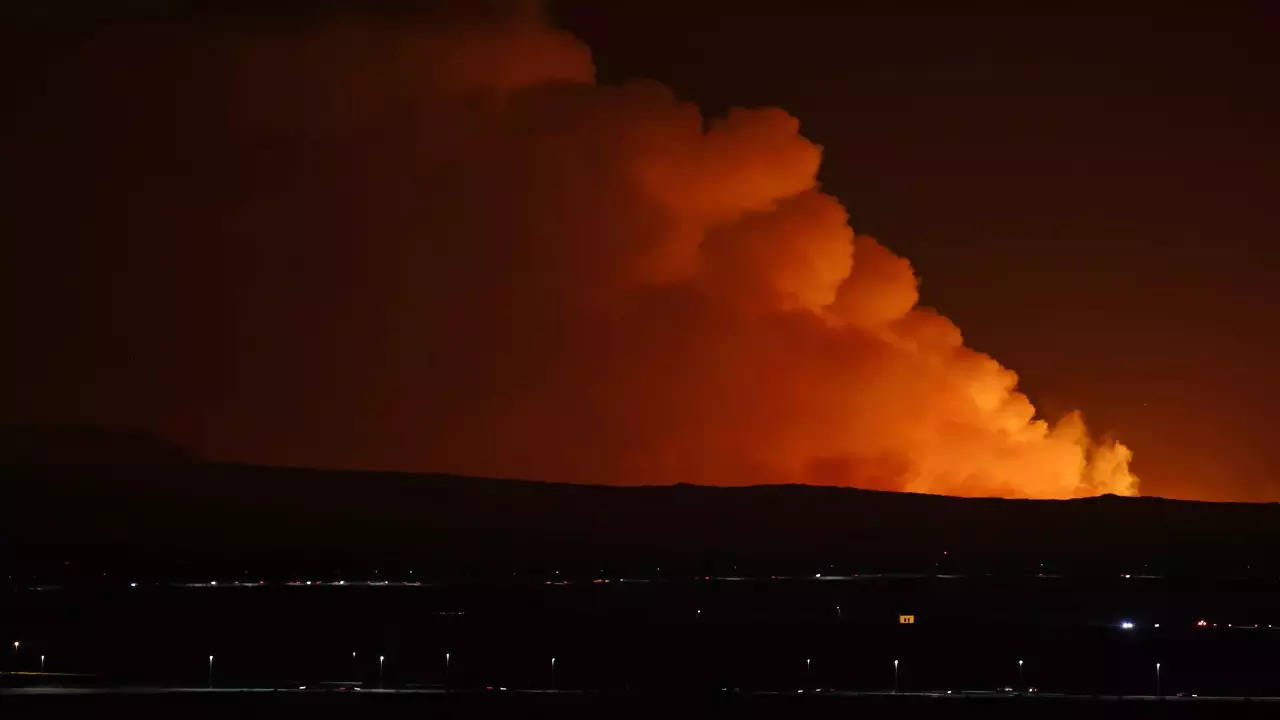 The night sky is illuminated caused by the eruption of a volcano on the Reykjanes peninsula of south-west Iceland seen from the capital city of Reykjavik