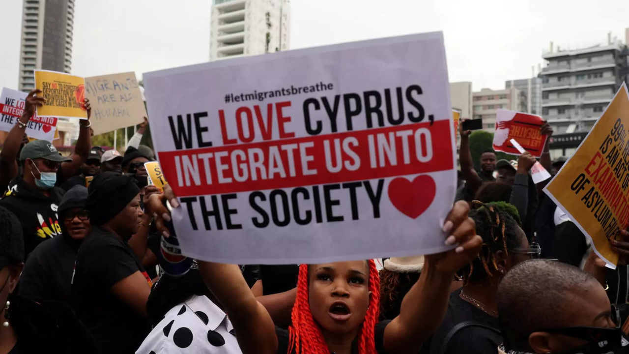 Migrants hold placards during a protest against Cypriot government changes in migration policy in Nicosia, Cyprus April 20, 2024 (Reuters photo)