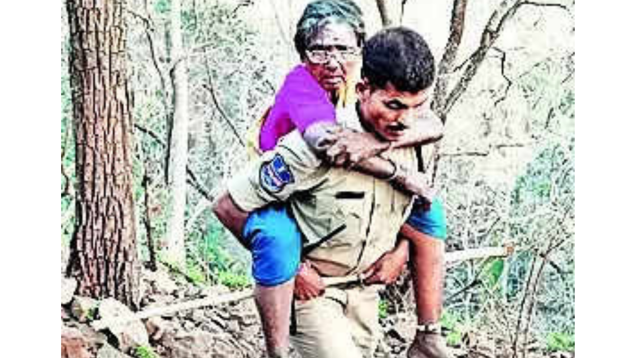 Constable Ramadas carries a devotee through the rocky terrain
