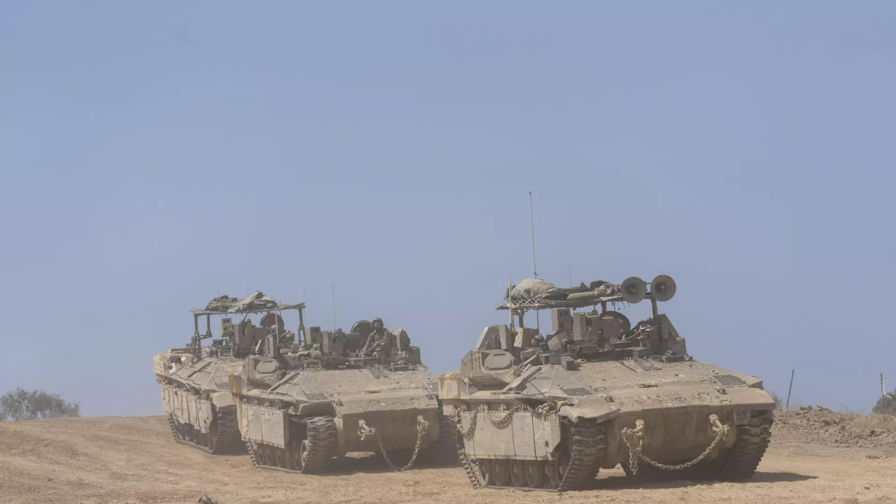 Israeli soldiers drive personnel carriers (APC) near the border with Gaza Strip, in southern Israel (AP photo)