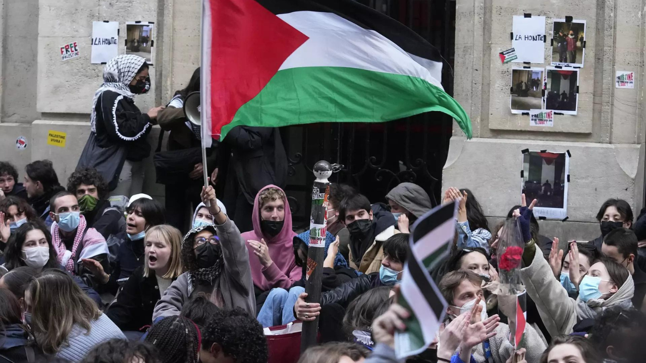 A student wave a palestinian flag outside Sciences-Po university in Paris Friday, April 26, 2024. (Photo/AP)