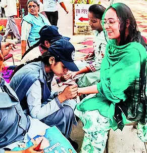 Pink sofas, rangolis and green carpets: Voters celebrate festival of democracy despite heat