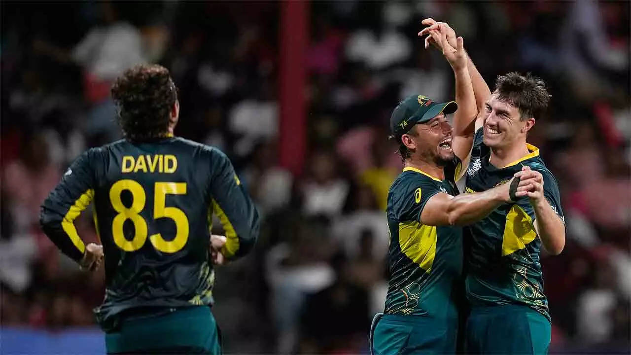 Pat Cummins is congratulated by Marcus Stoinis and Tim David during the match against Afghanistan. (AP Photo)