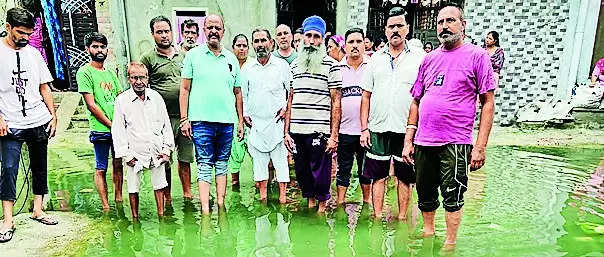 Residents stand in puddles to protest against civic officials