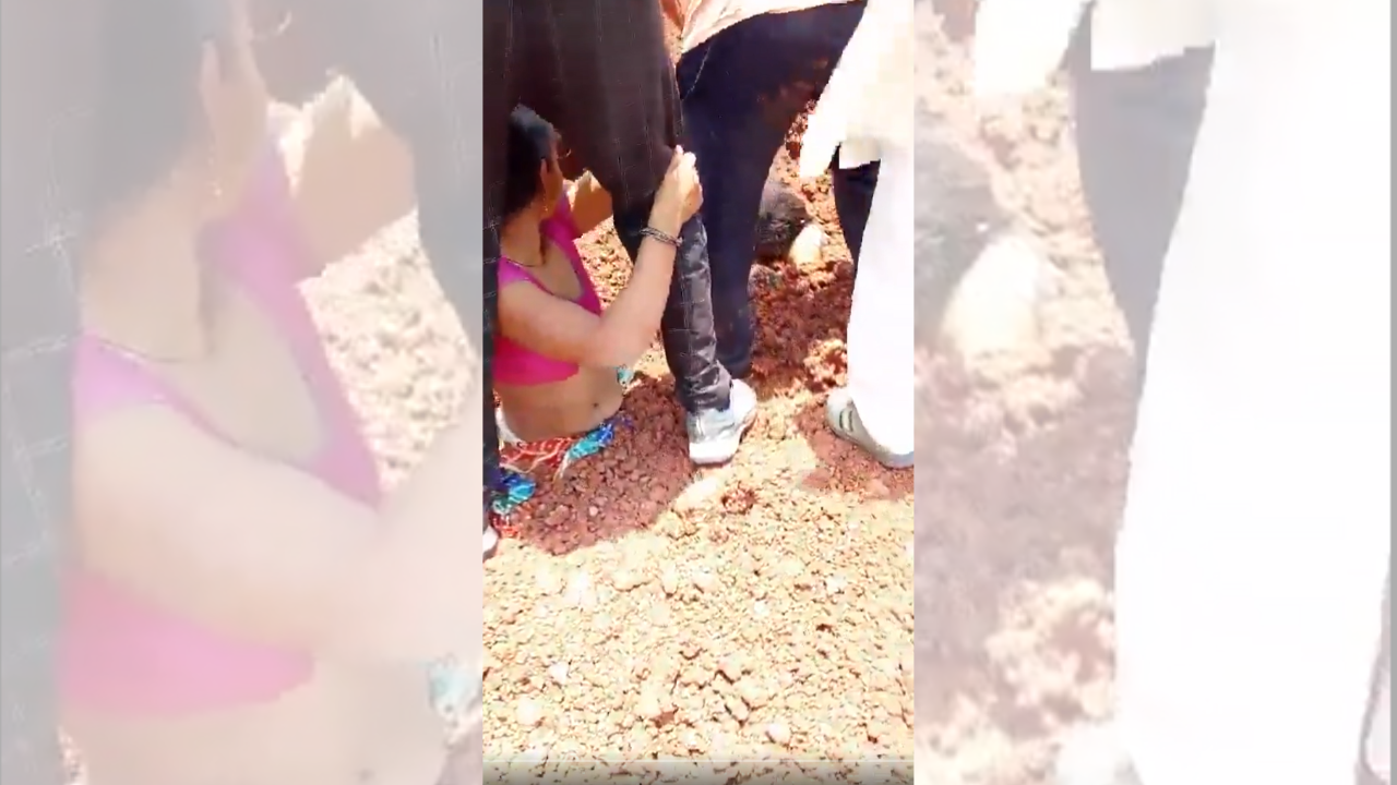 Two women partially buried in gravel during protest in Madhya Pradesh