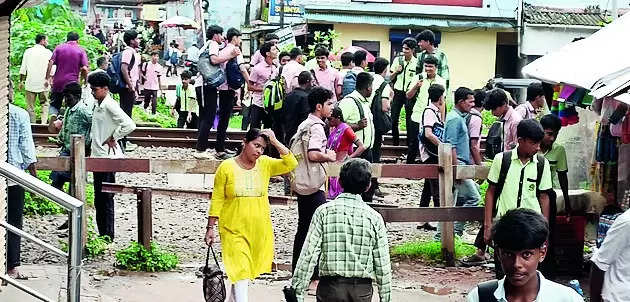 People cross tracks on foot due to lack of rly crossing