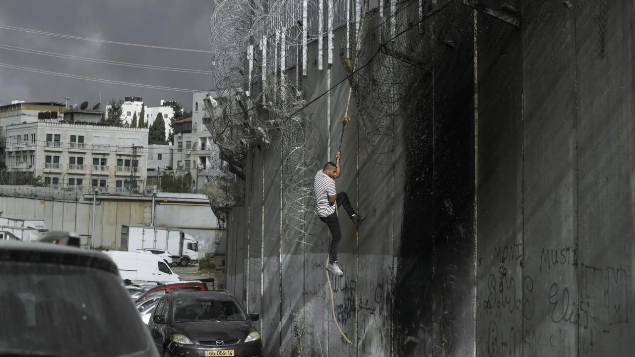 Palestinians in West Bank risk crossing Israel's separation barrier to flee failing economy