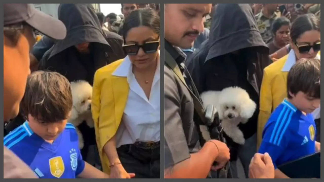 SRK holds cute puppy in hands as he return to Mumbai