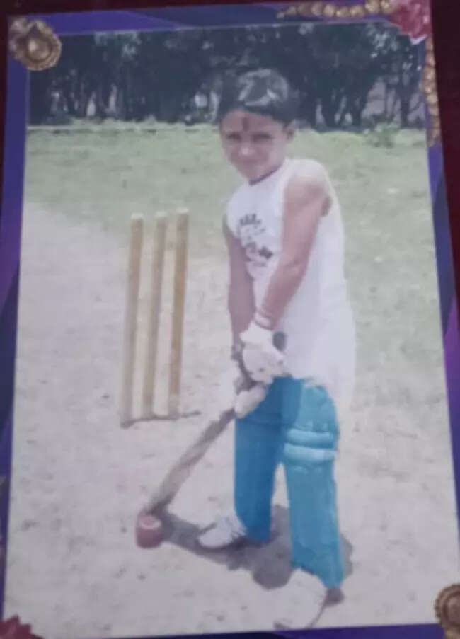 A 4-year-old Vipraj beams with his very first cricket kit, a gift from his parents.