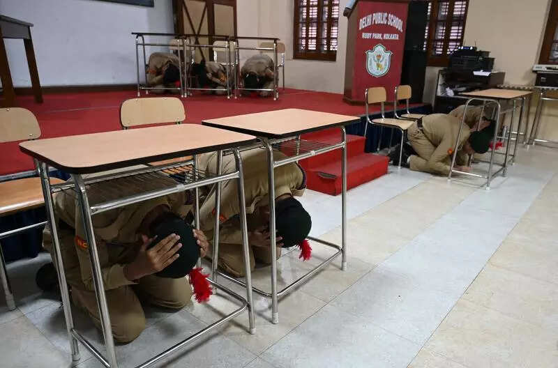 Kids dive under desks, learn safety protocol as city schools do the drill