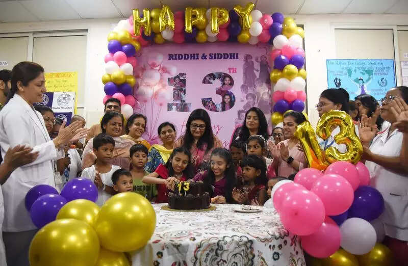 Once-conjoined twins, raised by hosp, turn 13