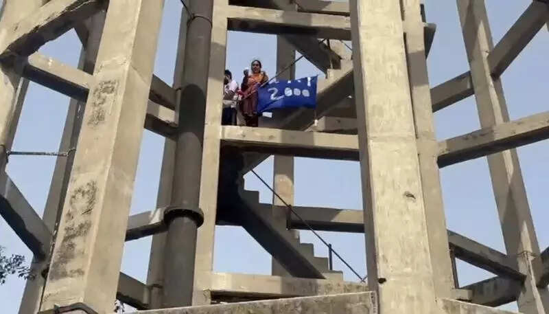PT union members climb up water tank over joblessness