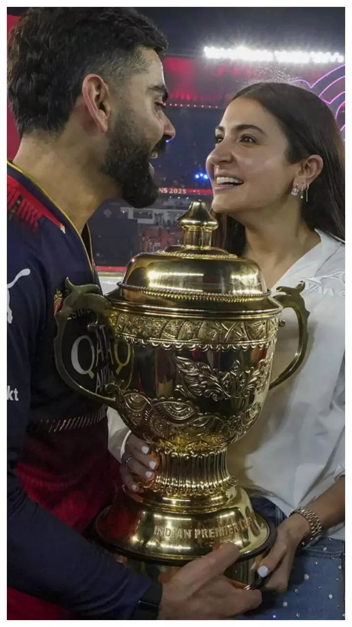Virat Kohli and Anushka Sharma are all smiles as they lift RCB’s first-ever IPL trophy - Pics