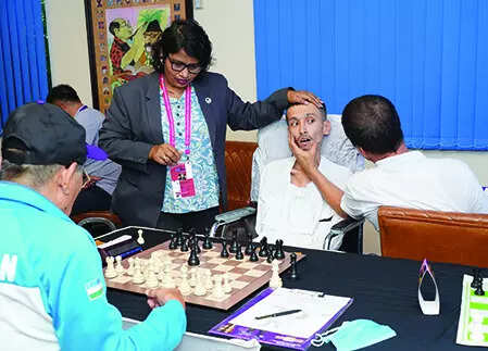 Moving chess pieces with just his eye, Abbas wins hearts, games with a smile