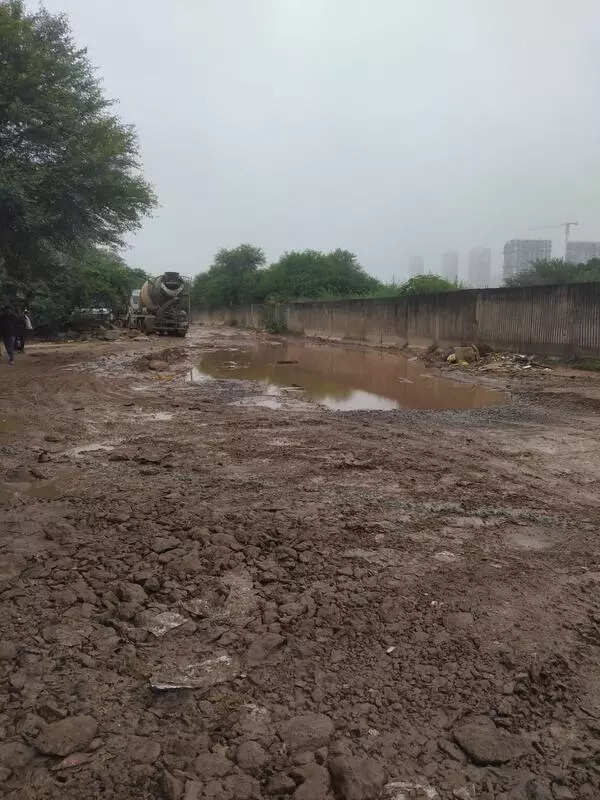 15 years on, road riddled with craters, Gurgaon Sector 65 residents seek proper condo link