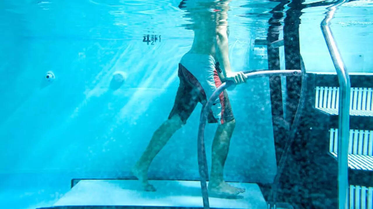 Stand straight in waist-deep water and begin walking