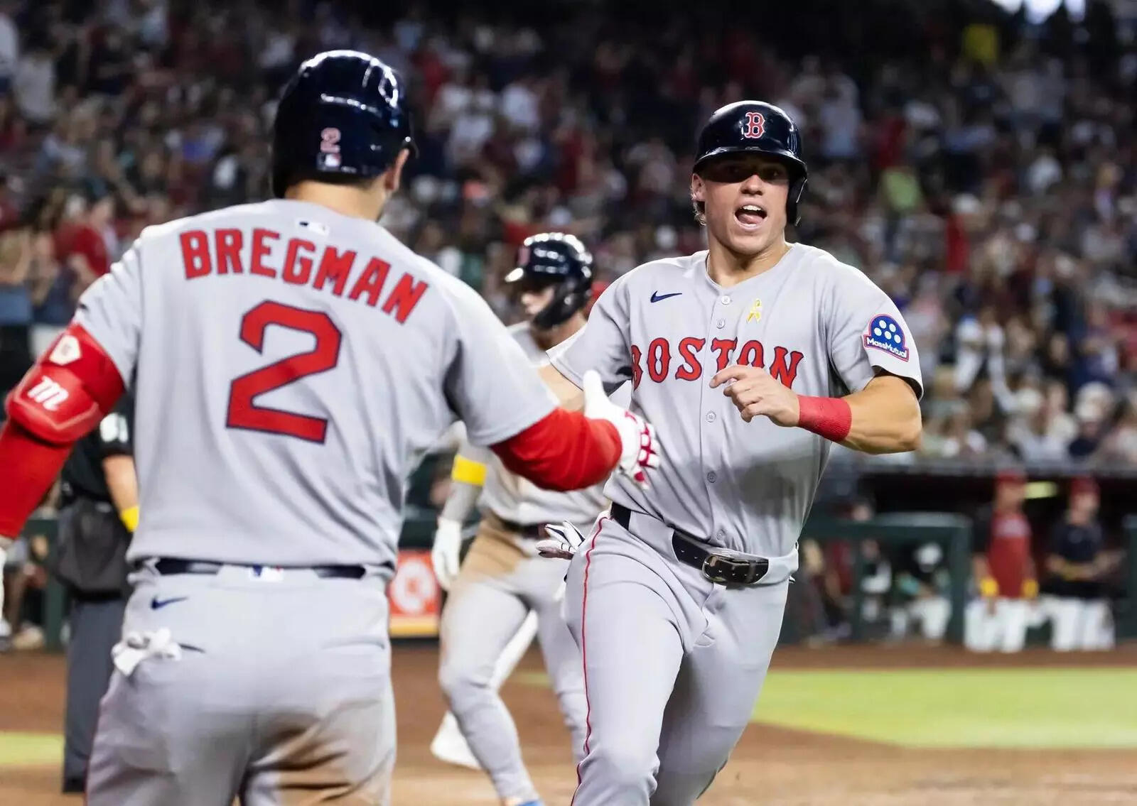 Boston Red Sox base runner Nate Eaton (right) celebrates with Alex Bregman after scoring in the ninth inning