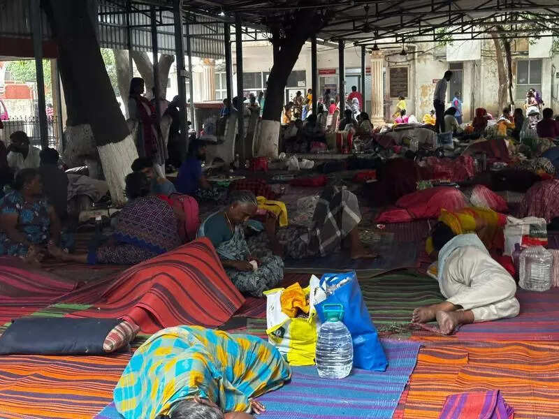 Families at IOG sleep on concrete, battle mosquitoes, rain, lack of water