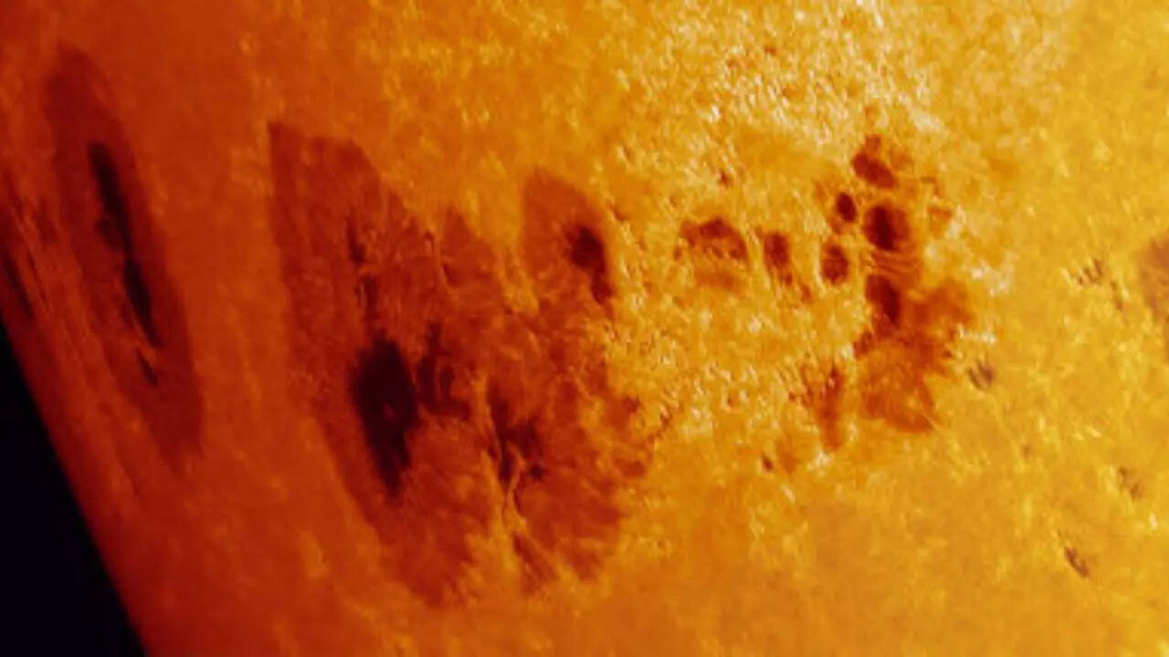 Why did a minor sunspot erupt while a huge one rotated toward Earth’s side