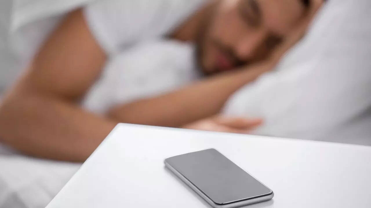 Sleeping next to your phone may cause brain cancer, fertility issues, and other hidden health risks, experts warn about