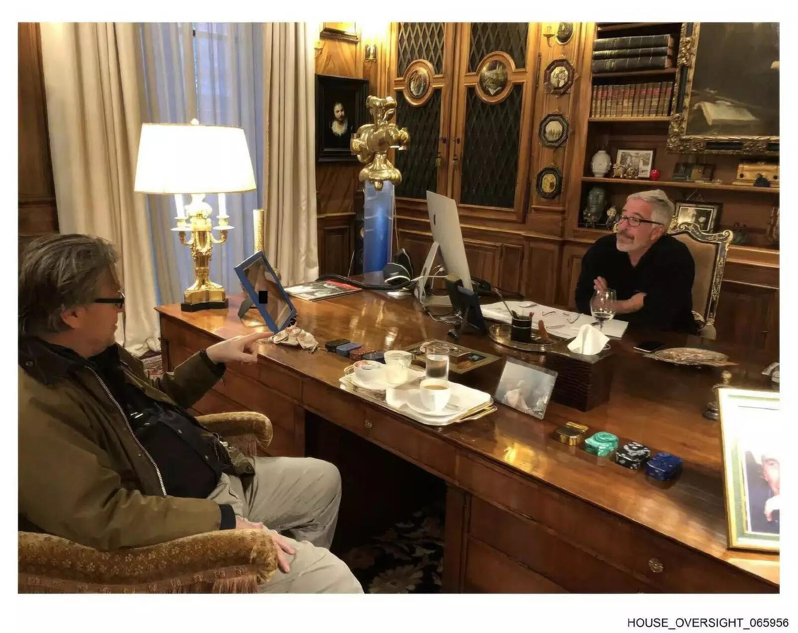This photo released by Democrats on the House Oversight Committee shows Jeffrey Epstein talking with Steve Bannon