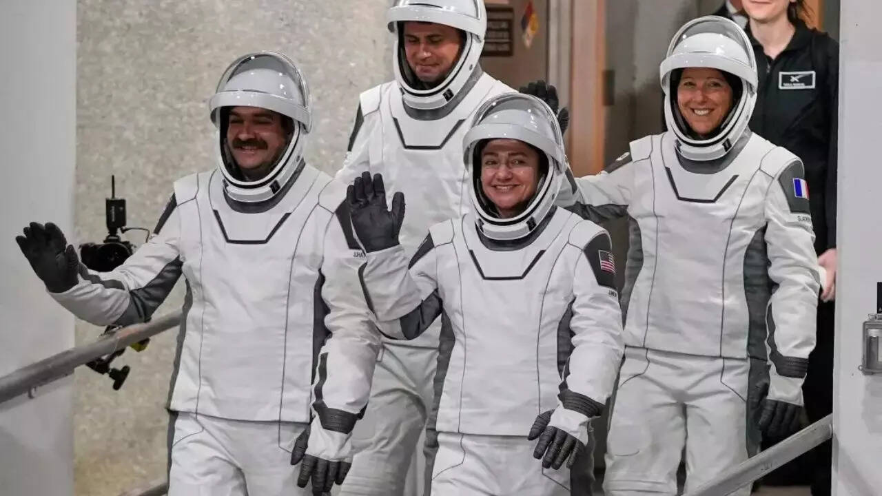 Four astronauts arrive at International Space Station via SpaceX to bring crew back to full strength