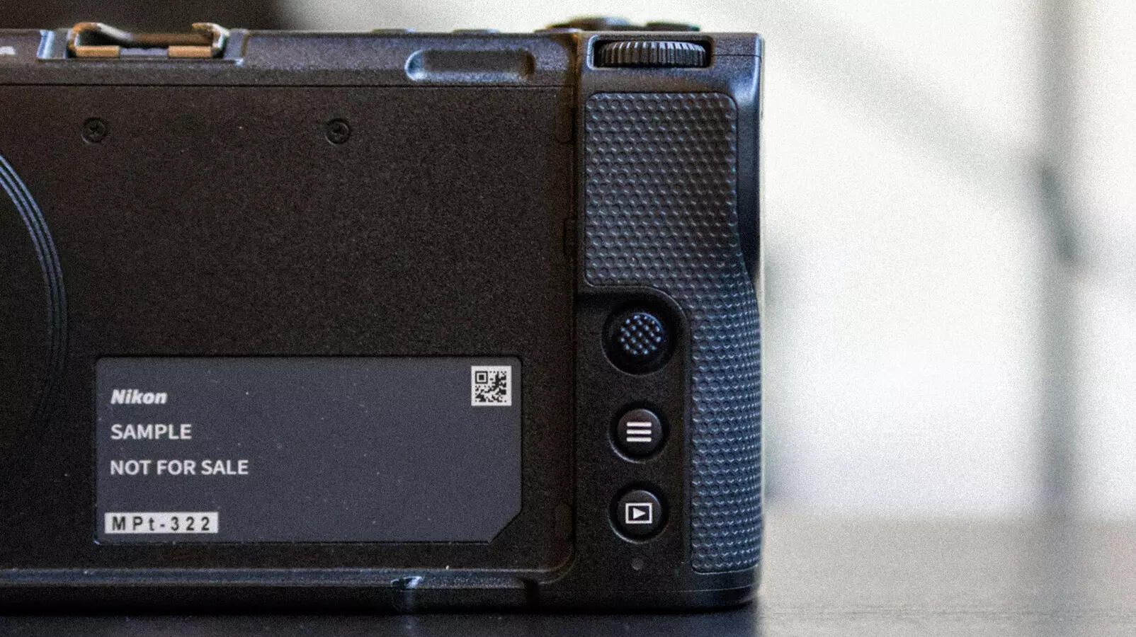 Rear controls are stripped to the bare minimum: joystick for focus, and two buttons for menu and playback