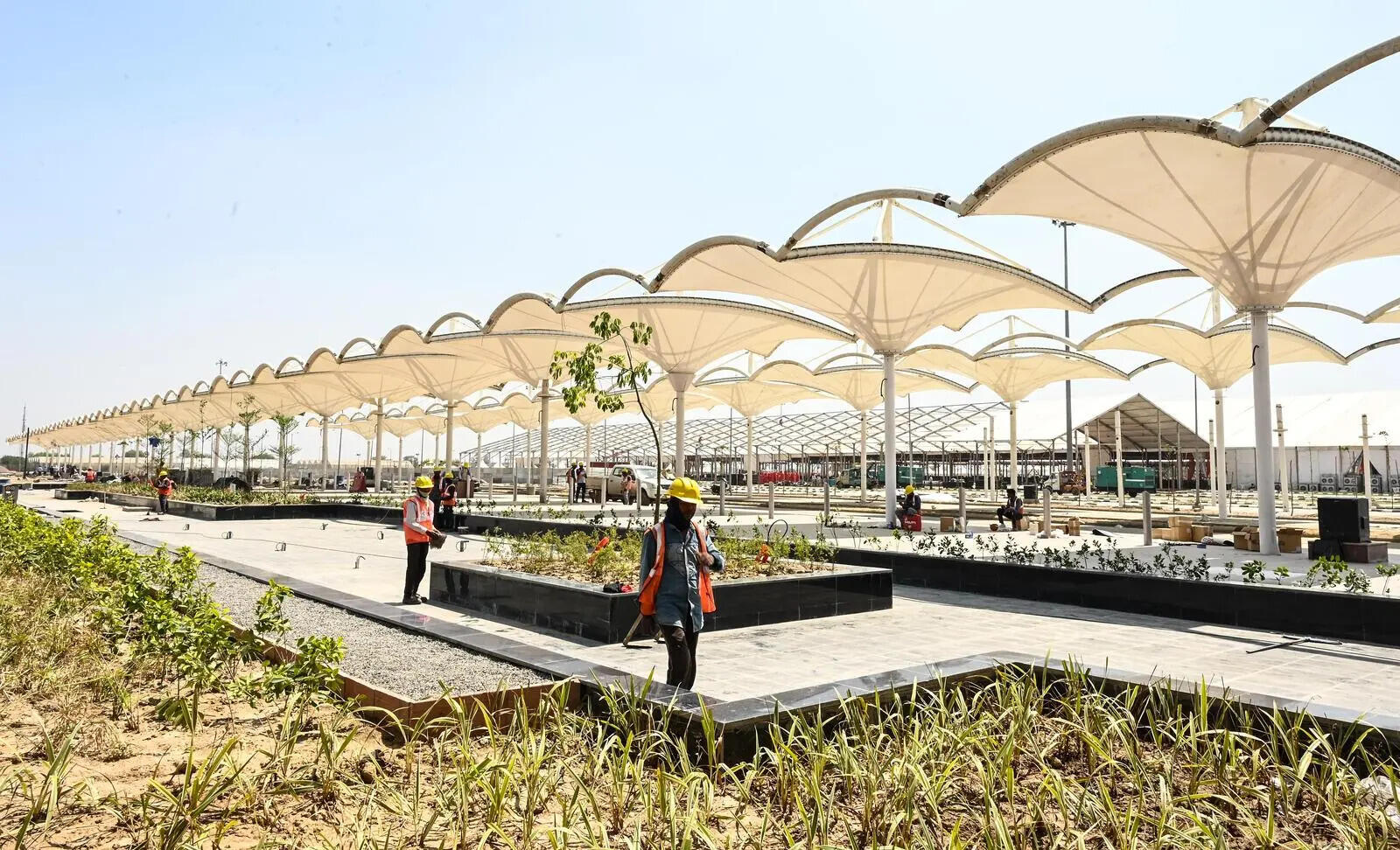Workers give the finishing touches to the passenger drop-off area of the NIA terminal building