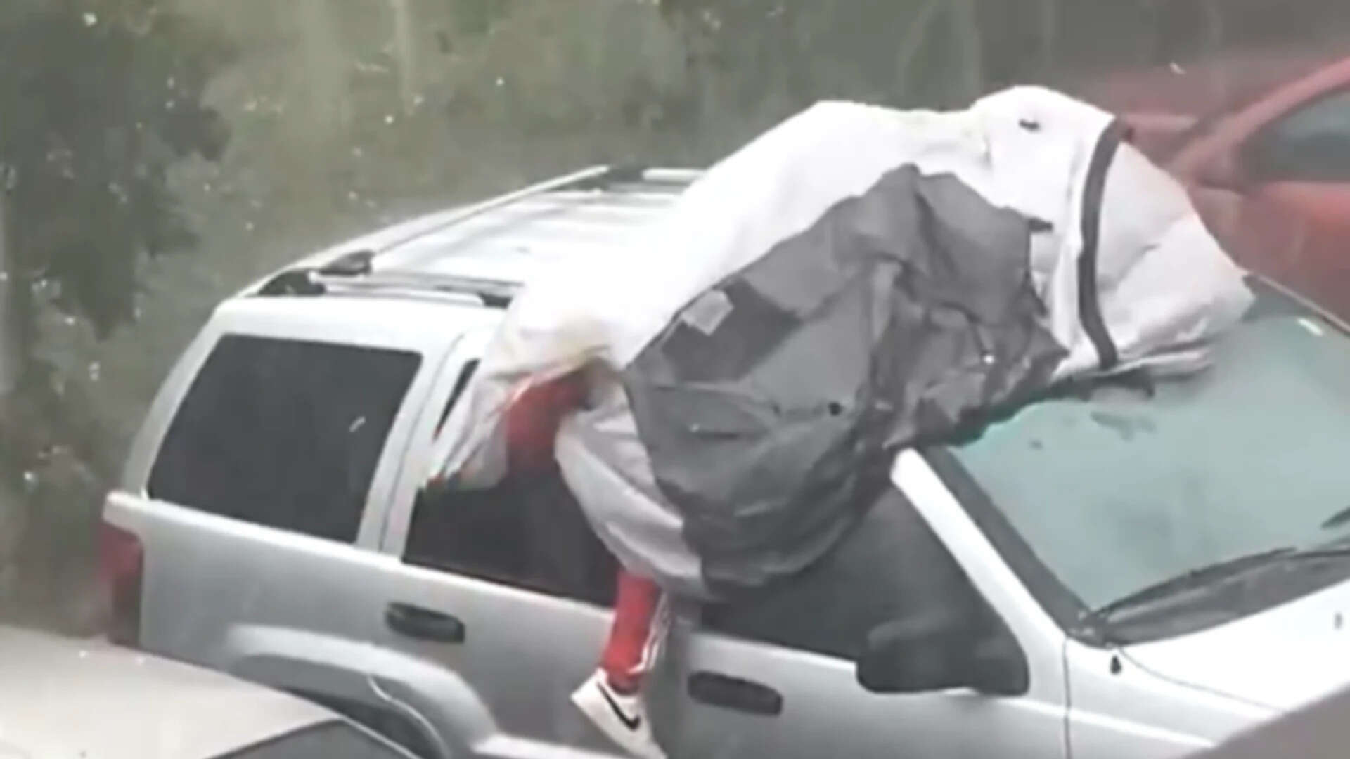 ‘Maybe he forgot insurance’: Florida man tries to protect car during hailstorm by lying on top of it