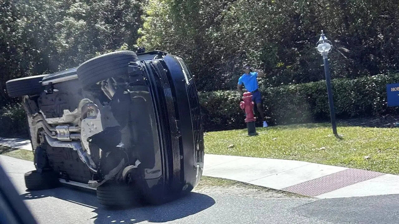 Tiger Woods is seen beside his overturned vehicle on Jupiter Island
