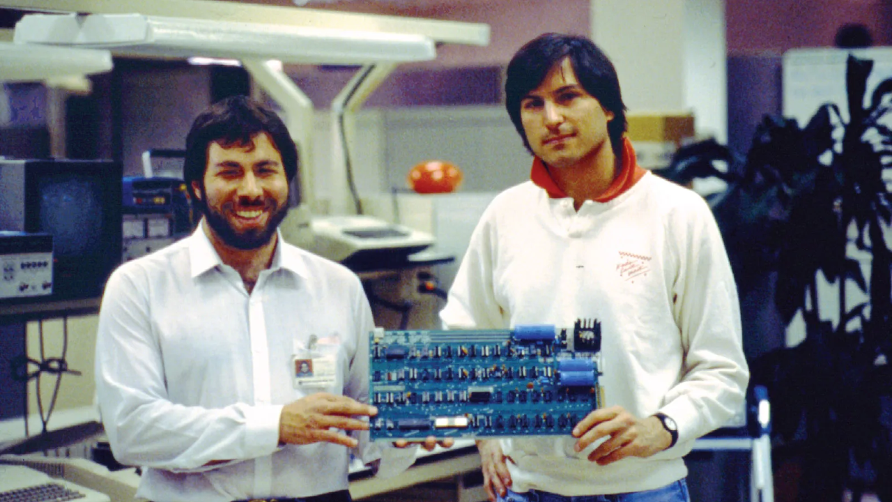 Steve Wozniak and Steve Jobs holding an Apple I circuit board in 1976