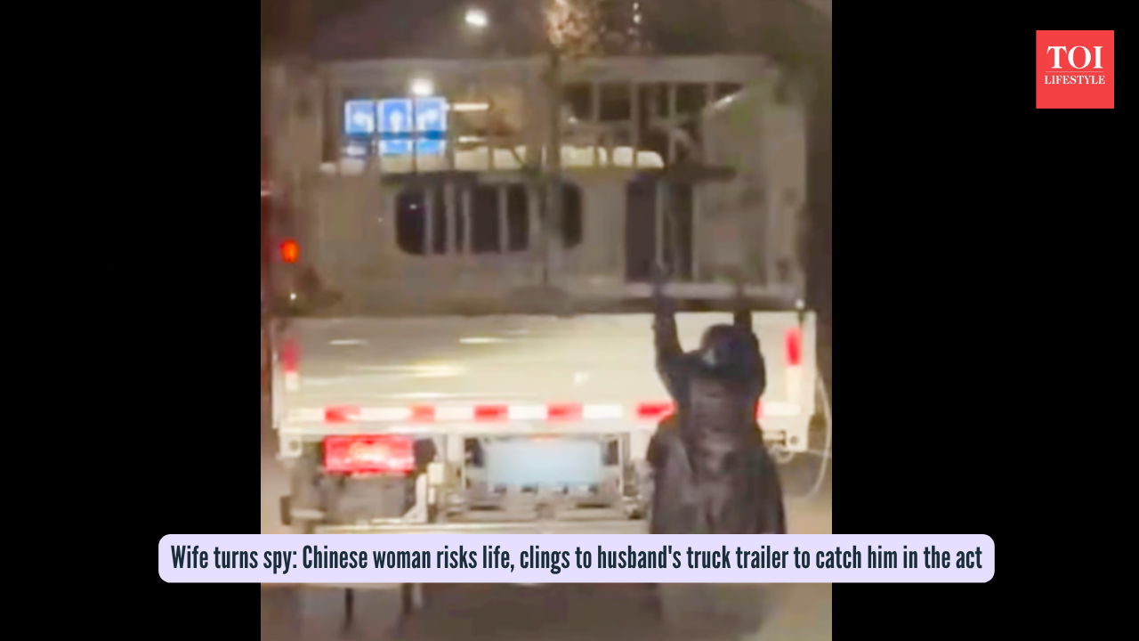 Wife turns spy Chinese woman risks life, clings to husband's truck trailer to catch him in the act