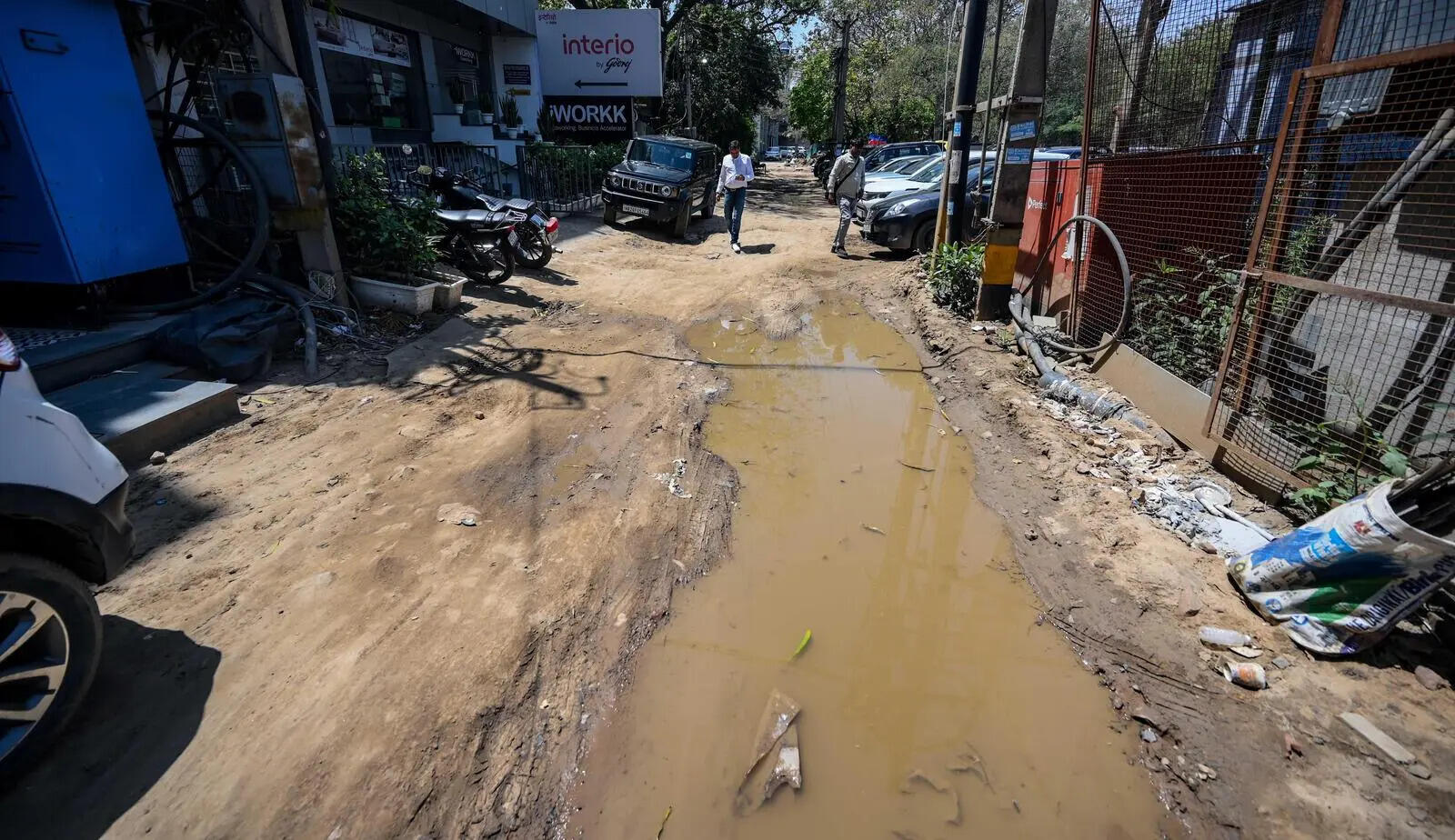 Illegal parking and broken service lane choke Old Mehrauli-Gurgaon Road