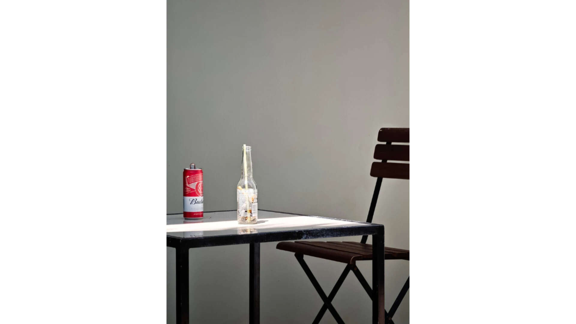 A can and bottle on table