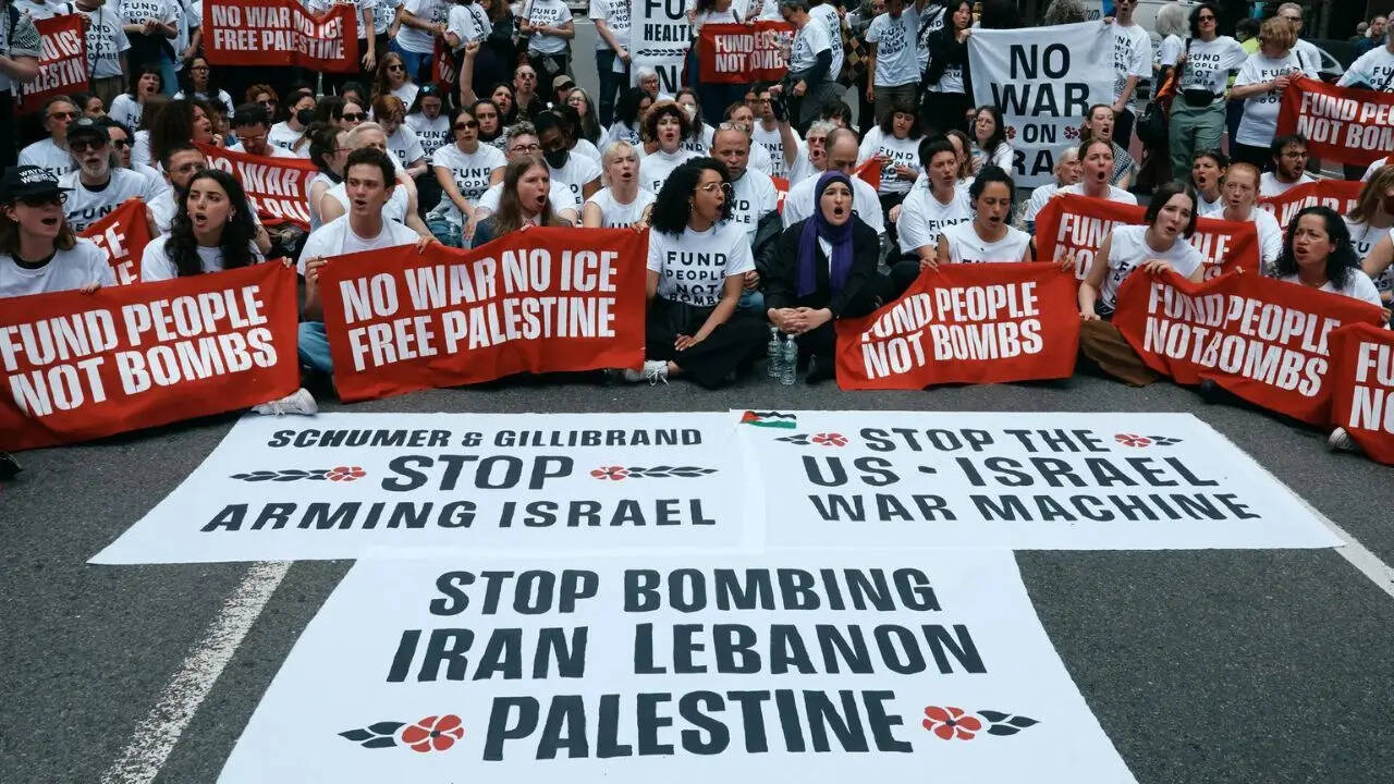 Chelsea Manning, fourth from left, and protesters with JVP blocking traffic to call for end to the US-Israel war against Iran