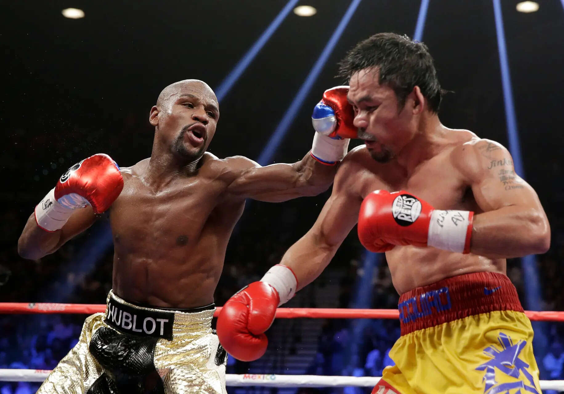 FILE - Floyd Mayweather Jr., left, hits Manny Pacquiao, from the Philippines, during their welterweight title fight on May 2, 2015, in Las Vegas. (AP Photo/Isaac Brekken, File) Floyd Mayweather and Manny Pacquiao agree to a rematch in September at The Sphere in Las Vegas