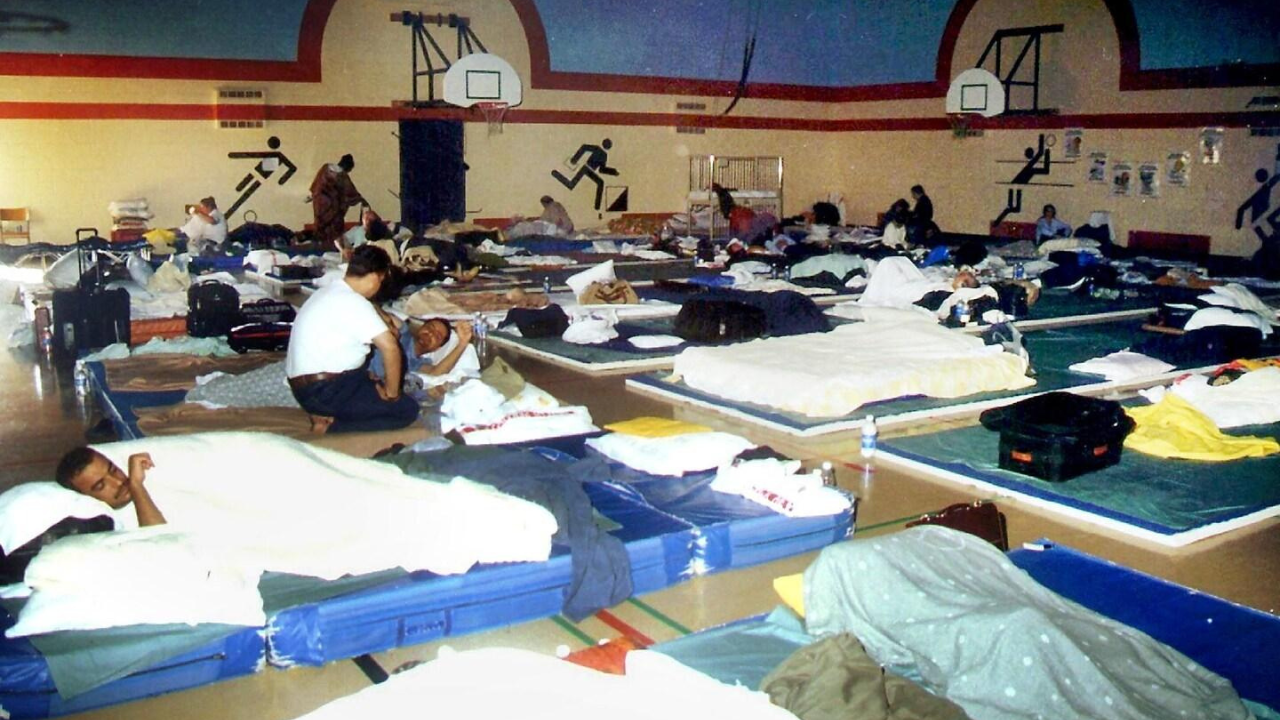 A school gymnasium in Gander converted into a temporary shelter, where stranded passengers were housed on cots and mattresses for several days.