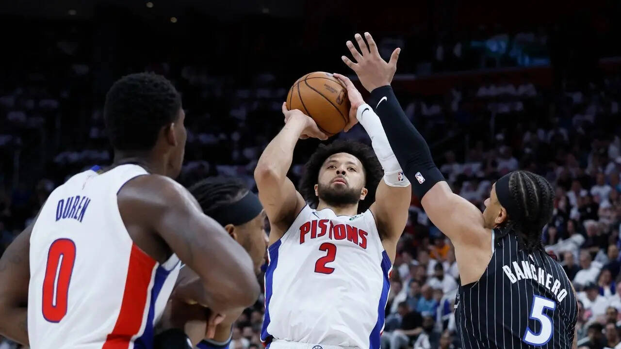 Cade Cunningham shoots over Paolo Banchero as Jalen Duren defends during first-half action in Game 2 of the Pistons-Magic playoff series, April 22, 2026, in Detroit