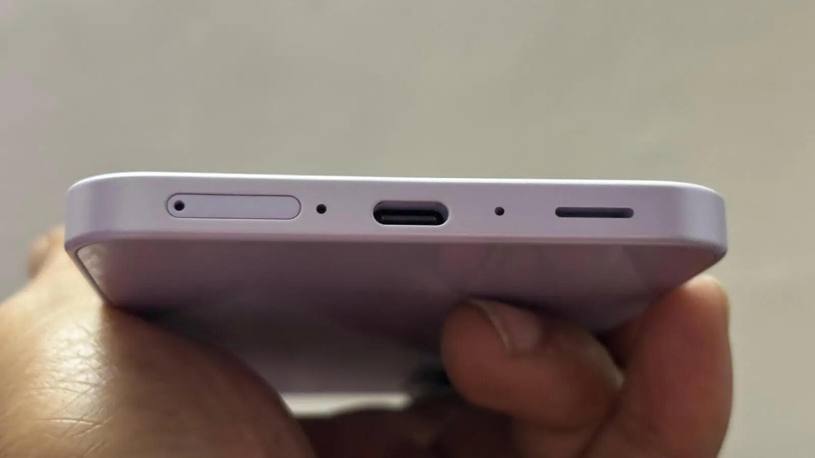 USB-C charging port, SIM tray and speaker grille