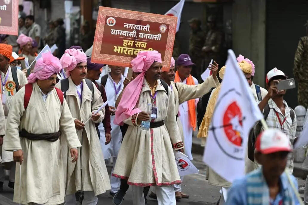 Tribal members carrying flags and banners take part in a tribal cultural march at Delhi’s Red Fort during the Janajati Sanskritik Samagam