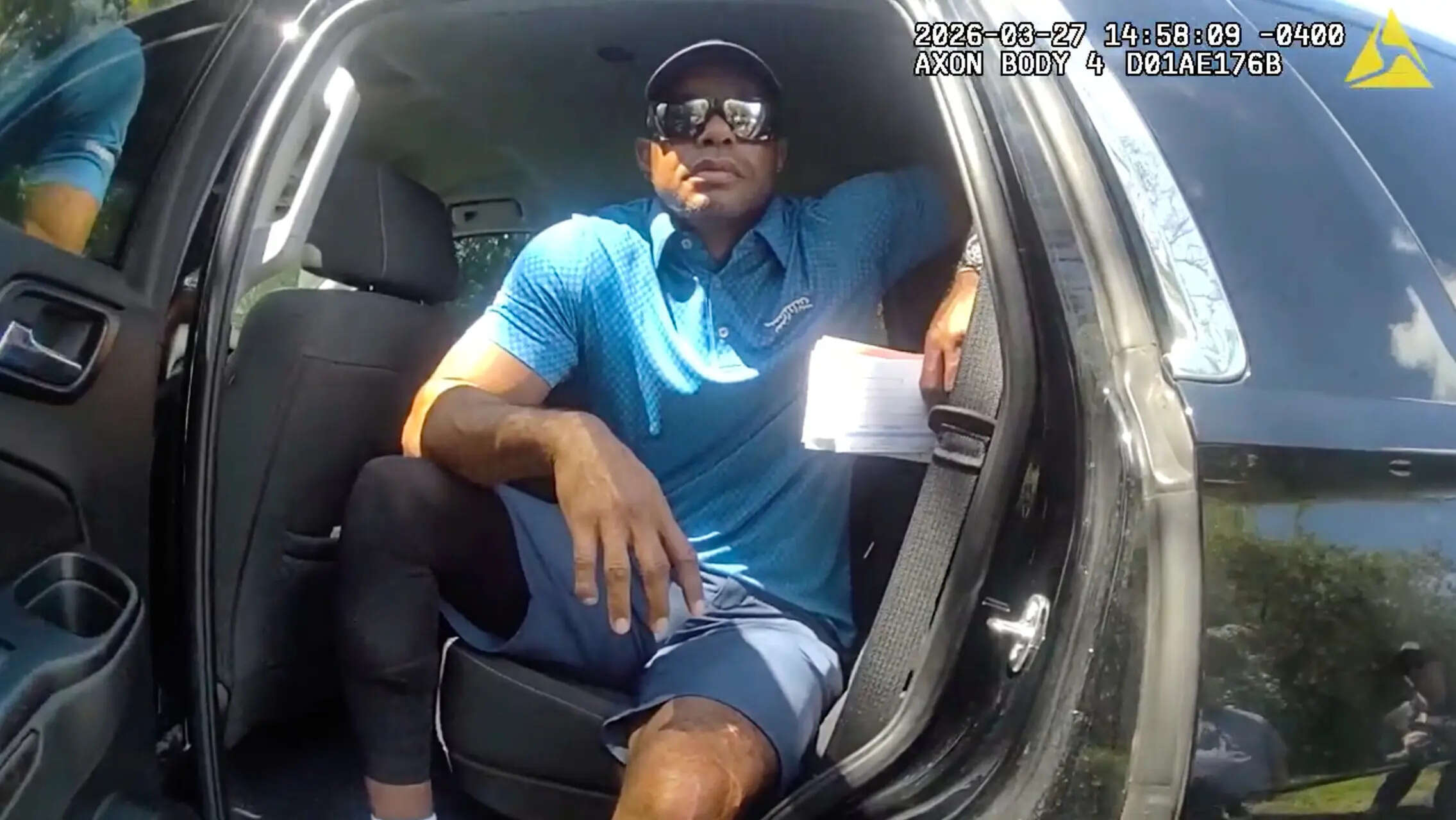 FILE - In this image from police body camera video released by the Martin County, Fla., Sheriff's Office, golfer Tiger Woods sits in an unmarked police vehicle as he speaks with law enforcement personnel following a car crash in Jupiter Island, Fla., March 27, 2026. (Martin County Sheriff's Office via AP, File) Tiger Woods’ prescription drug records will be handed over to prosecutors in Florida DUI case