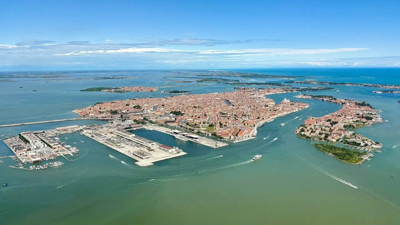 Which famous city is made up of 118 small islands in Italy and attracts millions of visitors each year
