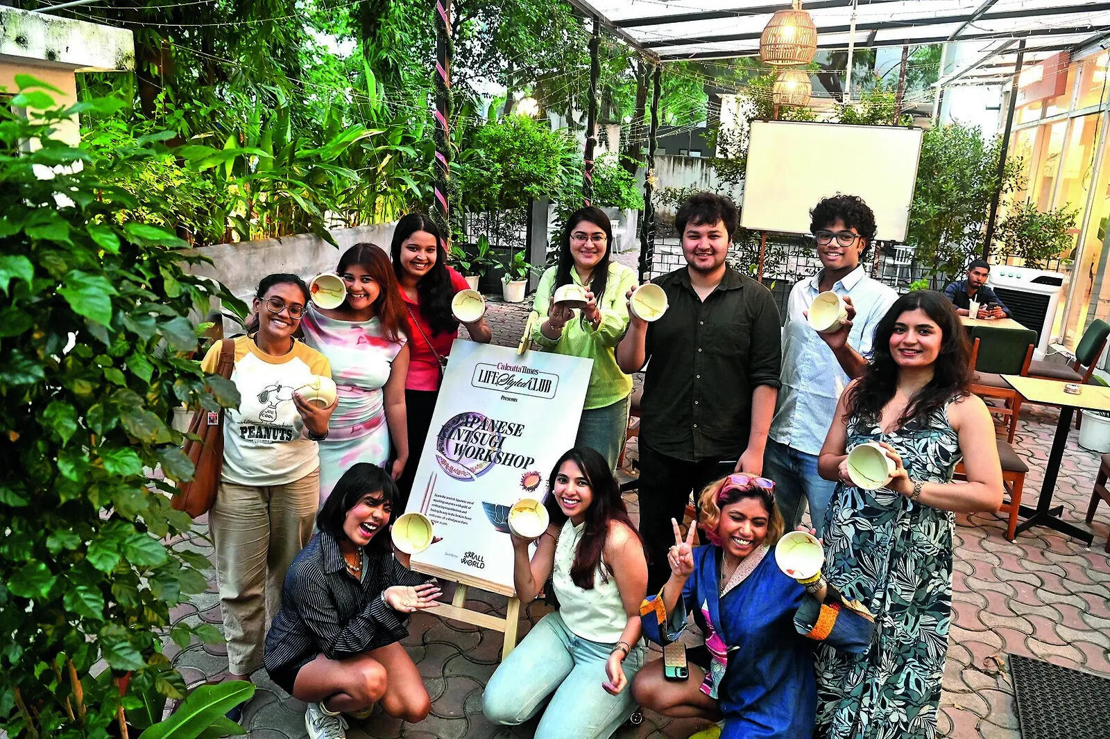 Attendees display their bowls, embellished with golden seams at the end of the workshop