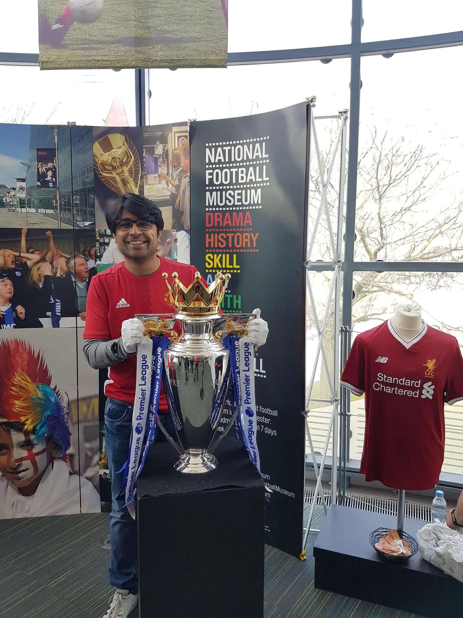 Chetan with the Premier League trophy at the National Footballs Museum