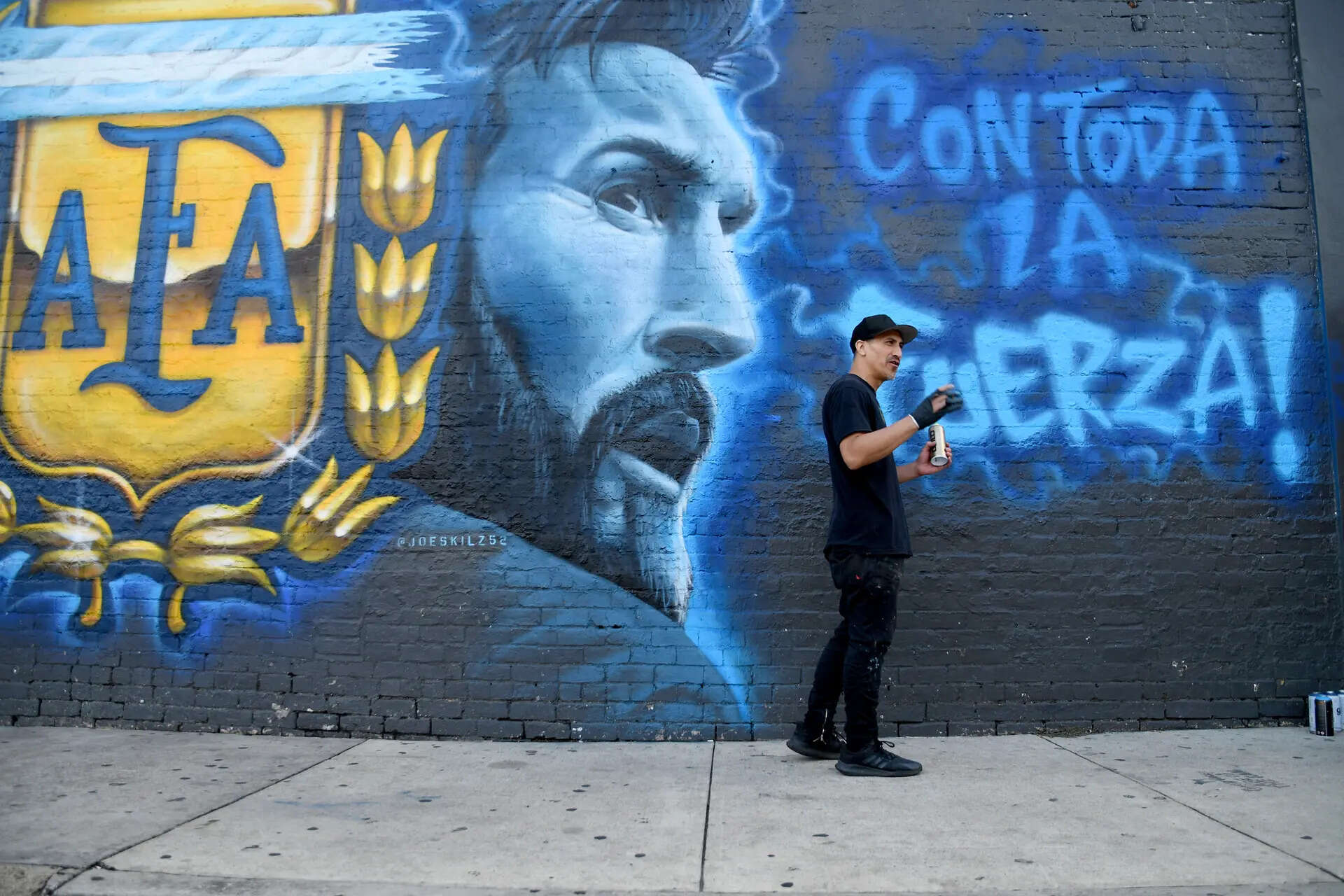 Artist Jose May, aka Joe Skilz, works on a mural of Argentina star Lionel Messi in Dallas on Friday, June 19, 2026. (AP Photo/Thomas Peipert) Texas WCup Soccer Argentina Messi Mural