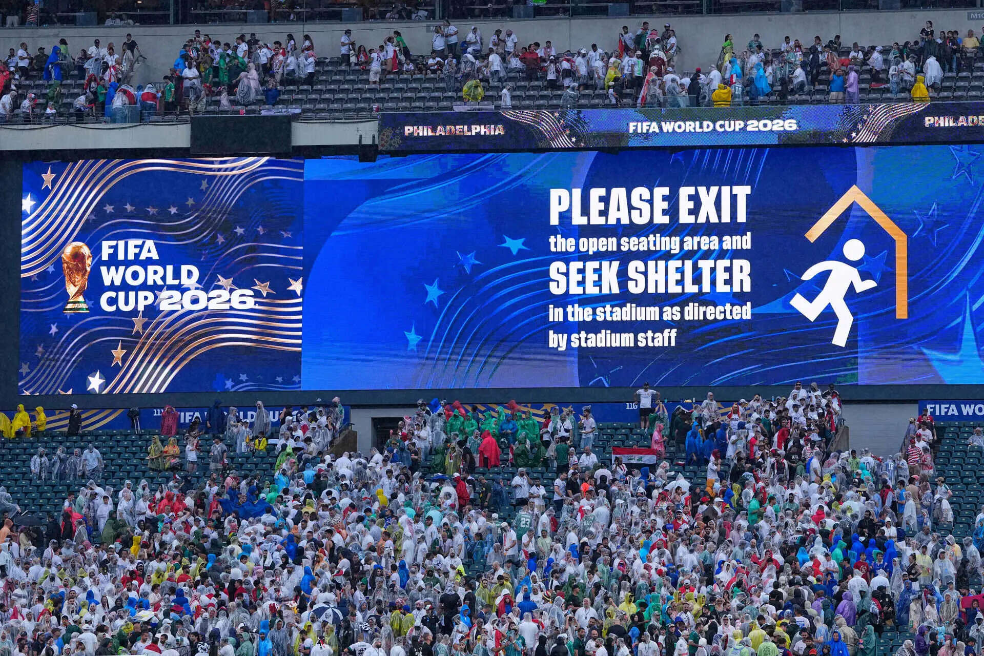 A sign is shown advising fans to exit seating as a severe weather storm hits during the World Cup Group I soccer match between France and Iraq in Philadelphia, Monday, June 22, 2026. (AP Photo/Petr David Josek) Iraq France WCup Soccer