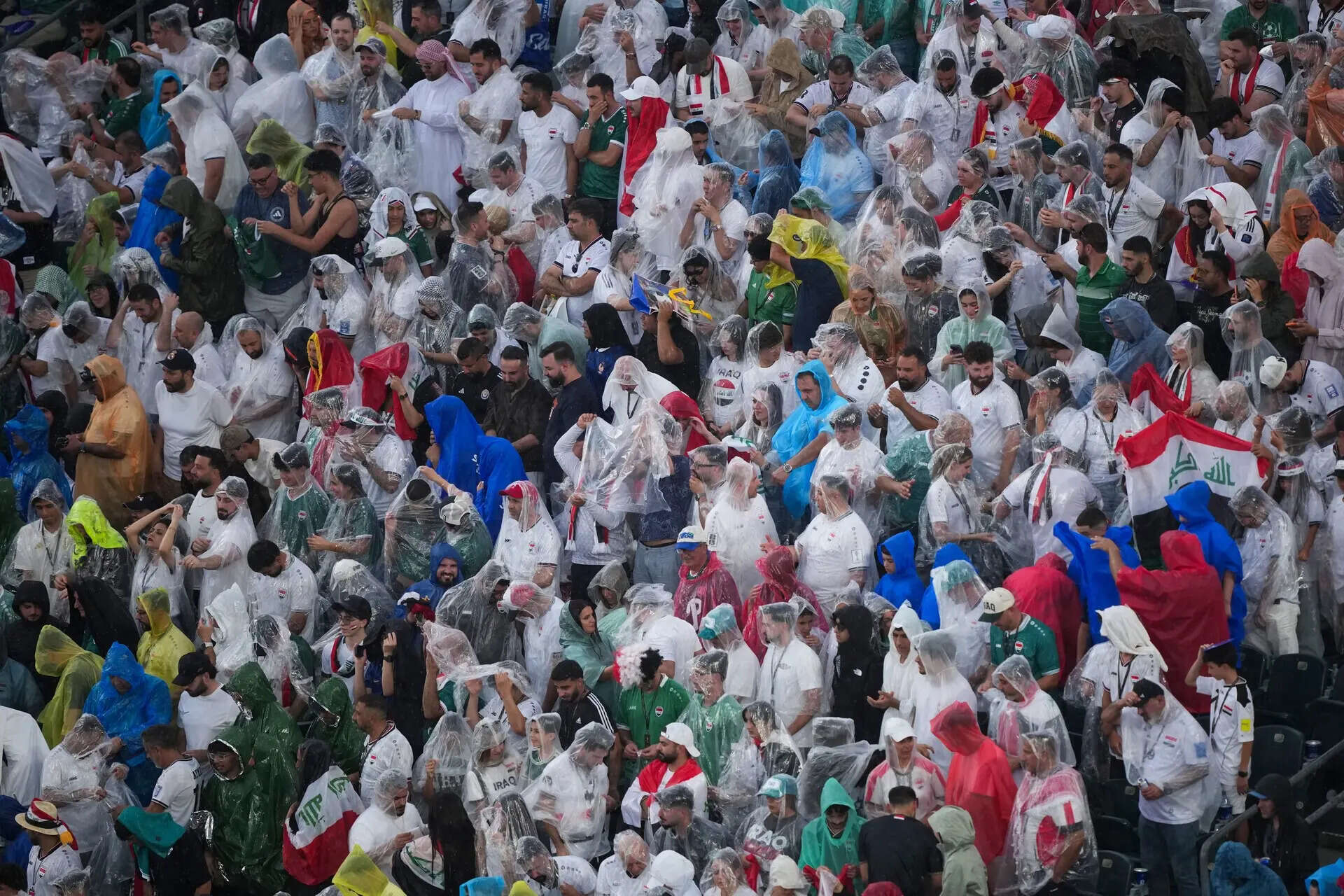 Fans wear ponchos to protect themselves from the rain during the World Cup Group I soccer match between France and Iraq in Philadelphia, Monday, June 22, 2026. (AP Photo/Matt Rourke) Iraq France WCup Soccer