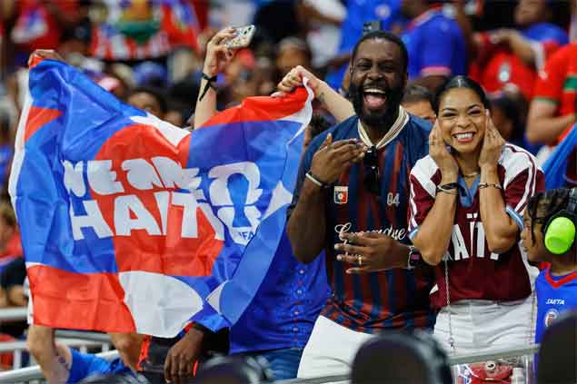 ​Haiti fans cheer during the FIFA World Cup match between Morocco and Haiti  (AP Photo)